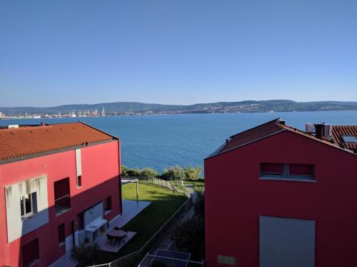 two buildings with a view of a body of water at Jan's Place at Seaside in Ankaran