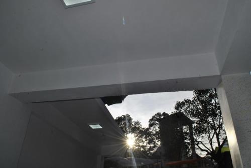 a view of the sun through a window in a building at Mountain Villa Adam's Peak in Adams Peak