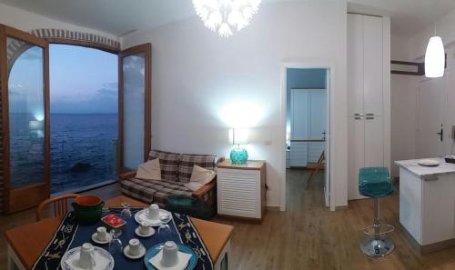 a living room with a view of the ocean at Gabbiano Azzurro Flat Chianalea in Scilla