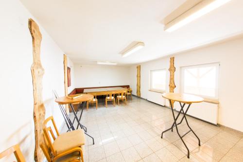 a room with a ping pong table and chairs at Landgasthof Seyrlberg in Reichenau im Mühlkreis