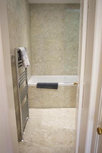 a bathroom with a bath tub and a shower stall at Mill Cottage in Lower Largo