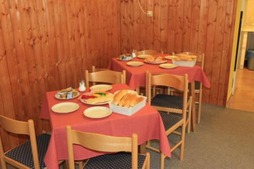 a dining room with two tables with food on them at Chata Javorina in Javorník