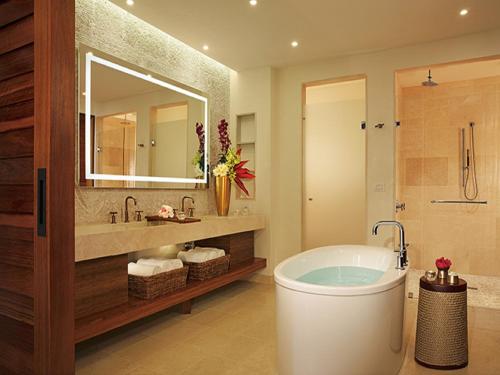 a bathroom with a tub and a sink and a mirror at Secrets Cap Cana Resort & Spa - Adults Only in Punta Cana