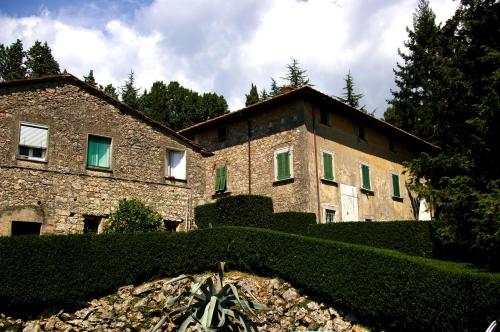 a large stone building with green shutters on it at Bed & Breakfast Villa Masini-Luccetti in Pietrasanta