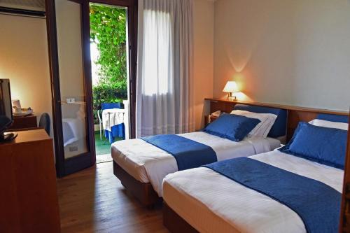 Ein Bett oder Betten in einem Zimmer der Unterkunft Hotel Bellavista
