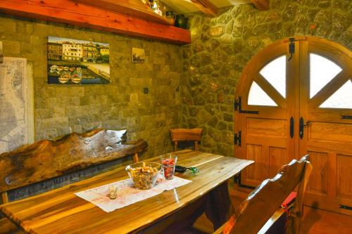 a wooden table in a room with a wooden door at Apartments Dada in Senj