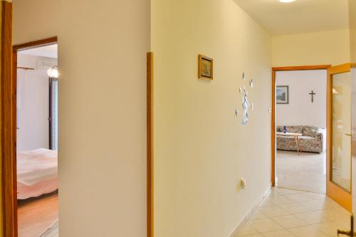 a hallway with a room with a bed and a mirror at Apartments Dada in Senj