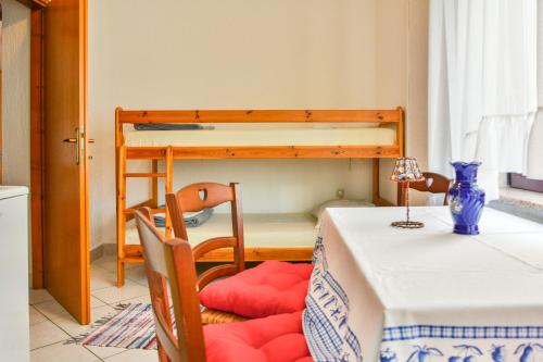 a dining room with a table and a bunk bed at Apartments Dada in Senj