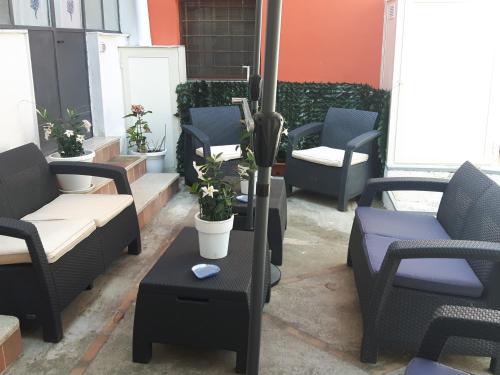 a group of chairs and tables on a patio at Penisola Apartment in Vico Equense