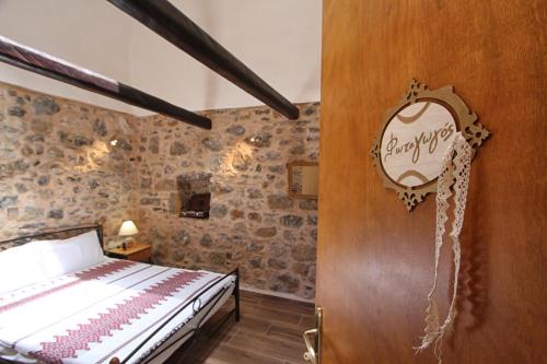 a bedroom with a bed and a wooden door at Schinos Apartments in Mesta