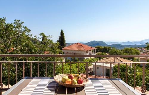 a basket of fruit on a table on a balcony at Karya Villas in Kariá