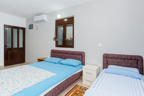 a bedroom with two beds and a window at MC Apartments in Ulcinj