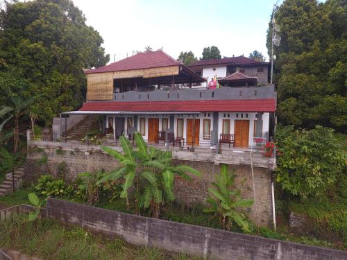 a house sitting on top of a hill at Adila Warung and Homestay in Munduk