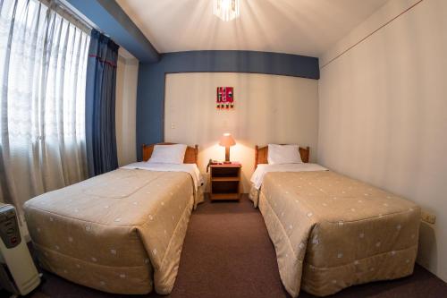 Postel nebo postele na pokoji v ubytování Hotel T'ika