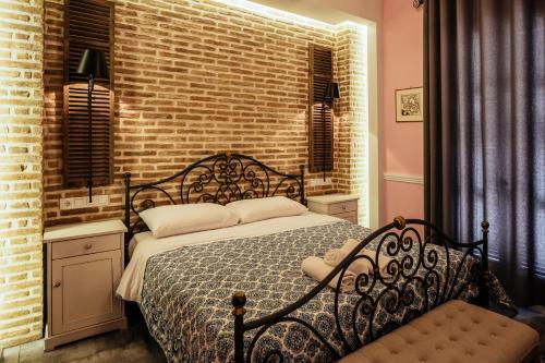 a bedroom with a bed and a brick wall at pension Acronafplia B&D in Nafplio