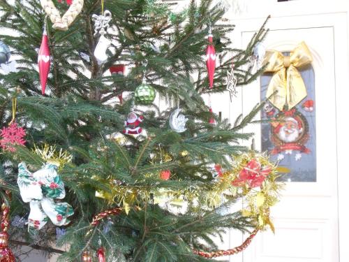 a christmas tree with christmas ornaments on it at Viola Vendégház in Kehidakustány