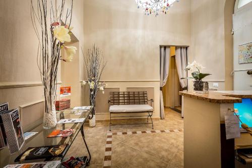 a living room with a chair and a table at Sognando Firenze in Florence