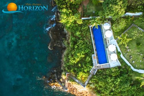 an overhead view of a swimming pool next to the ocean at Villa Infinite Horizon in Amed