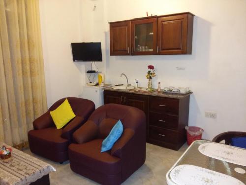 a living room with two chairs and a desk at Southern Comforts - Galle Fort in Galle