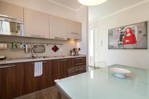 a kitchen with a counter and a sink and a counter top at Apartments La Lombarda Centro Storico Stresa in Stresa