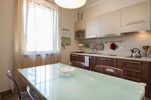 a kitchen with a glass counter top in a room at Apartments La Lombarda Centro Storico Stresa in Stresa