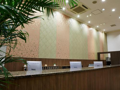 a waiting room with a large wall with at S.Training Center Hotel Osaka in Osaka
