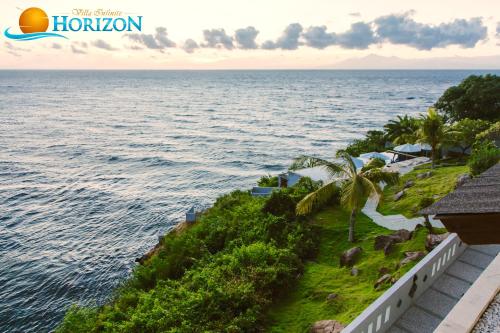 a view of the ocean from the balcony of a resort at Villa Infinite Horizon in Amed