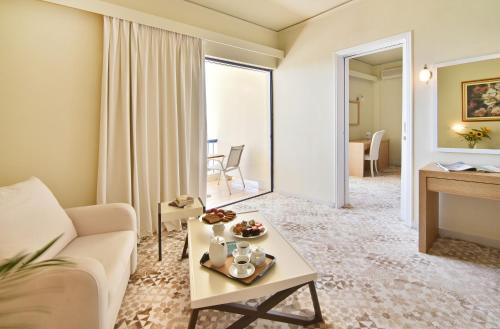 a living room with a couch and a table at Ionion Star Hotel in Lefkada Town