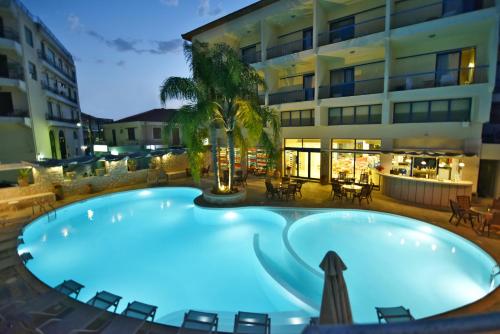 a large swimming pool in front of a building at Ionion Star Hotel in Lefkada Town