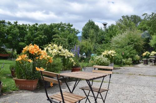 a picnic table and benches in a garden at Casa Miguel in Olea