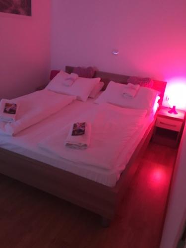 a bedroom with a large bed with pink lighting at Lugarnica in Zagreb