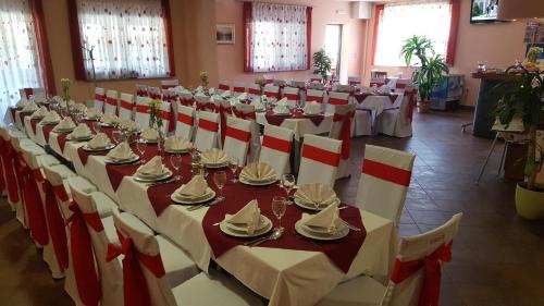 a large banquet hall with white tables and chairs at Lugarnica in Zagreb