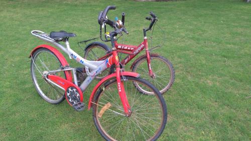 two bikes parked next to each other on the grass at The Meadows Resort and Spa in Aurangabad