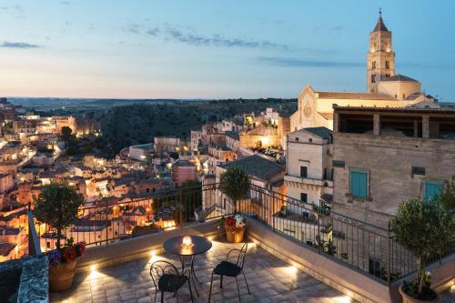 a view of a city from a balcony at night at Antica Torre di Iuso in Matera