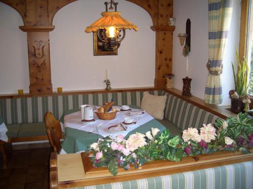 a table with a blue table cloth and flowers on it at Gästehaus Burgi in Fügen