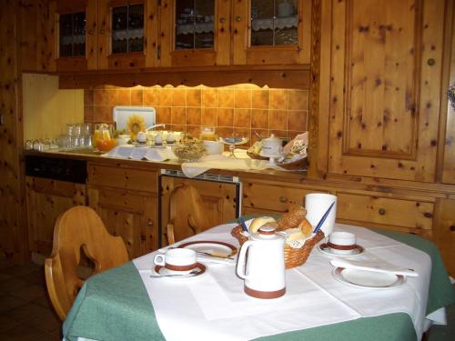 a kitchen with a table with food on it at Gästehaus Burgi in Fügen