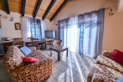 a living room with two couches and a tv at Kazanegra Exclusive Apartments in Sveti Stefan