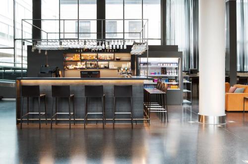 a bar in a large room with chairs and tables at Comfort Hotel Union Brygge in Drammen