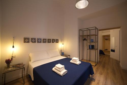 a bedroom with a bed with two towels on it at Borgo Vergini Garden B&B in Naples