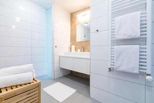 a white bathroom with a sink and a mirror at Vagabond Corvin in Budapest