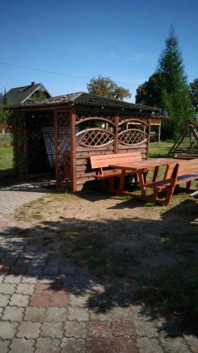 a picnic table and a gazebo in a park at Sominy Urlop na Kaszubach in Sominy