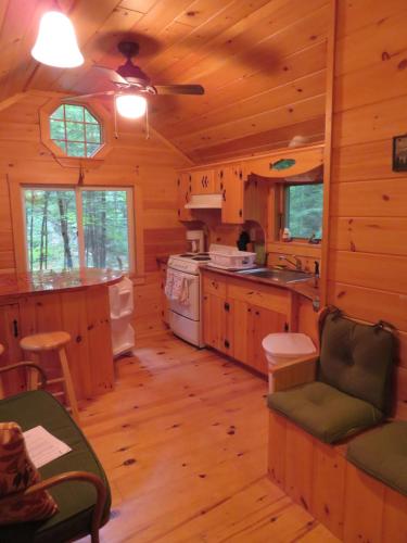 a large kitchen with wooden floors and a ceiling at Okie Dokie Cabins in Tamworth