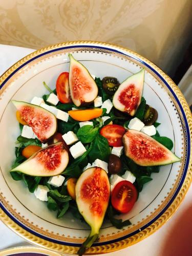 a plate of food with figs and other vegetables at Willa Różana in Nałęczów