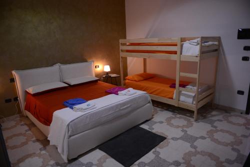 a bedroom with a bunk bed and a ladder at Bed & breakfast "MAZZINI" in Leverano