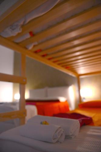 a bed with two white towels on top of it at Bed & breakfast "MAZZINI" in Leverano