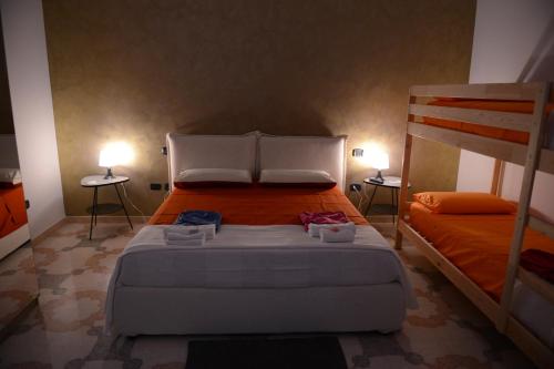 a bedroom with a bed and two bunk beds at Bed & breakfast "MAZZINI" in Leverano