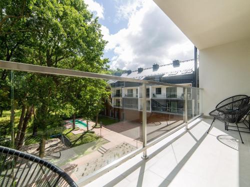 a balcony with a view of a building at Apartament 59 Dwie Sosny in Ustronie Morskie