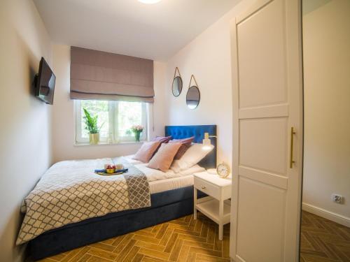 Кровать или кровати в номере Apartament 59 Dwie Sosny