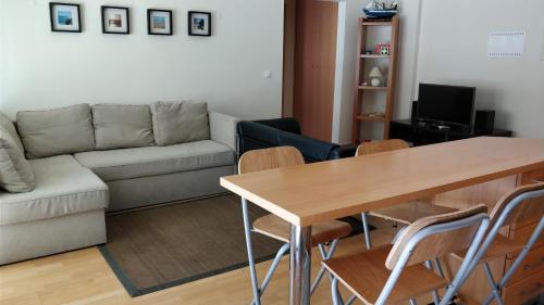 a living room with a table and a couch at Flat Sines in Sines