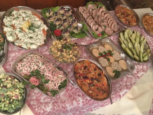 a table with a bunch of different types of food at Villa Bartosz in Międzywodzie